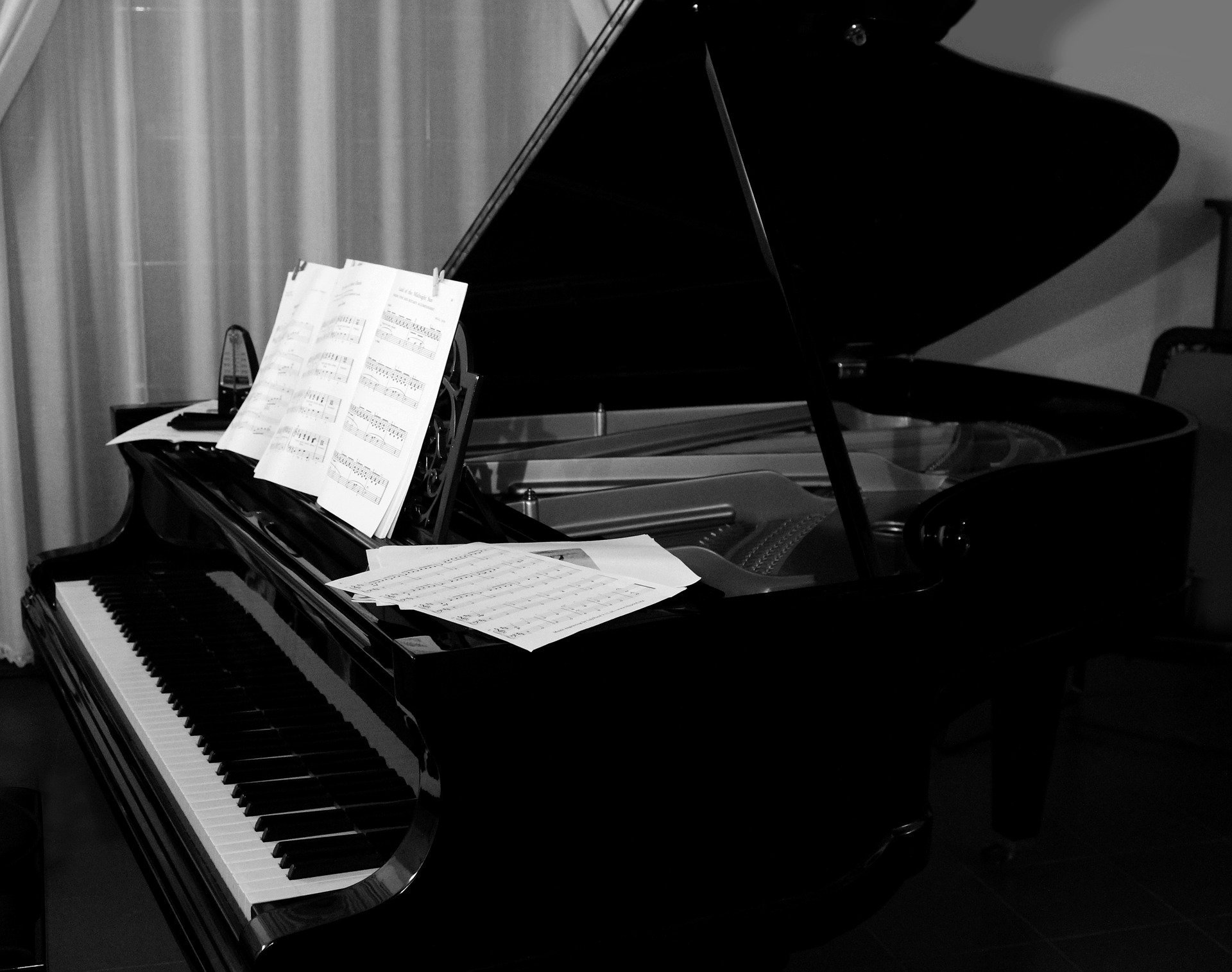 Music on Stream. Represented by a Black and white photo of a Grand Piano.